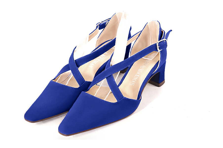Electric blue open side elegant shoes, with crossed straps. Tapered toe. Low kitten heels.